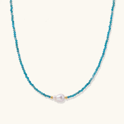 Dainty teal apatite beaded necklace with a single freshwater pearl centerpiece flanked by two small gold beads, adjustable gold clasp.