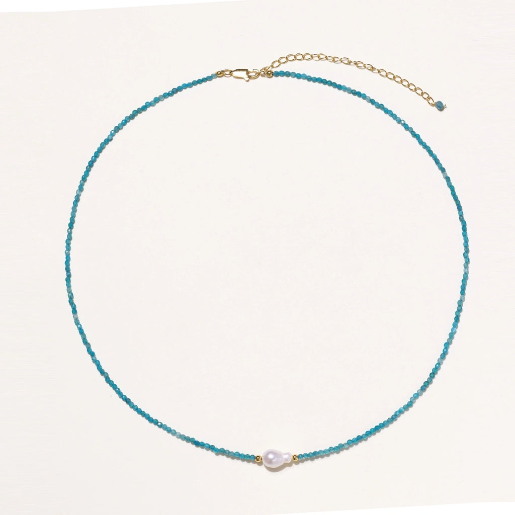 Dainty teal apatite beaded necklace with a single freshwater pearl centerpiece flanked by two small gold beads, adjustable gold clasp.